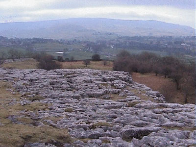 The limestone pavement with Grassington and Cracoe Fell in the background