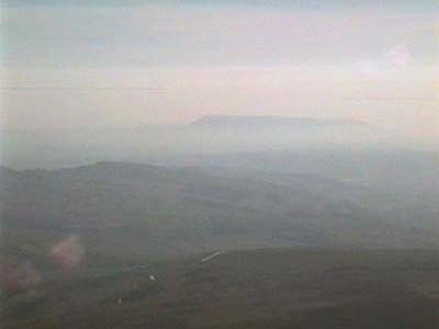 View down to Pendle Hill through the mist from the summit