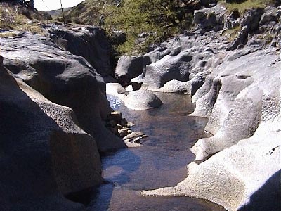 The stragely eroded rocks under the footbridge