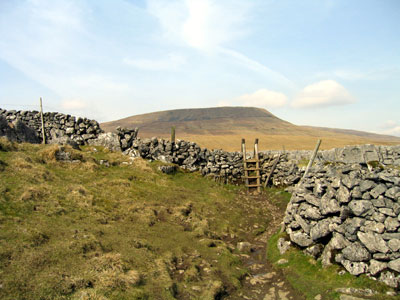 Stile leading to limestone pavement, Simon Fell on the horizon