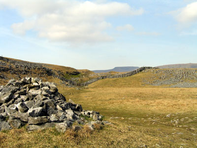 The cairn marks the way to the stiles ahead