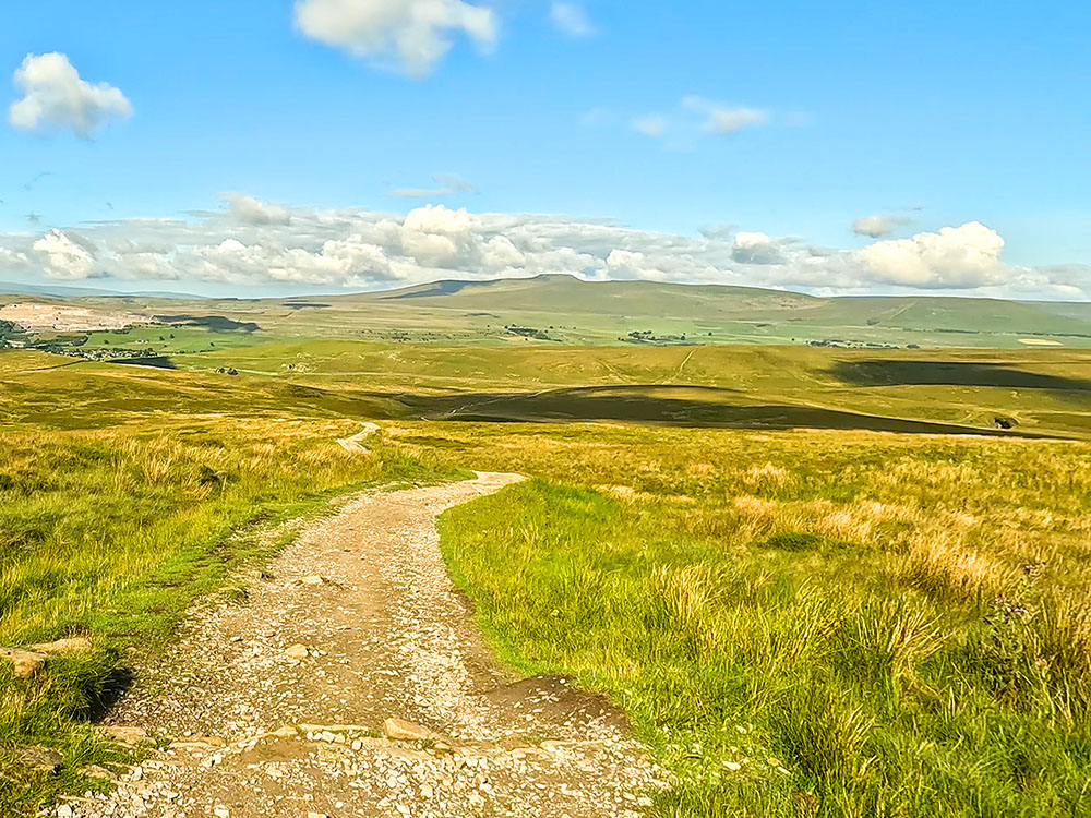 The path down off Pen-y-ghent, with Ingleborough on the horizon ahead