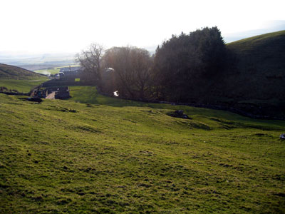 Path leads across the field to pull in by the stream