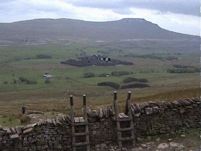 The two stiles with Bruntscar Farm down below